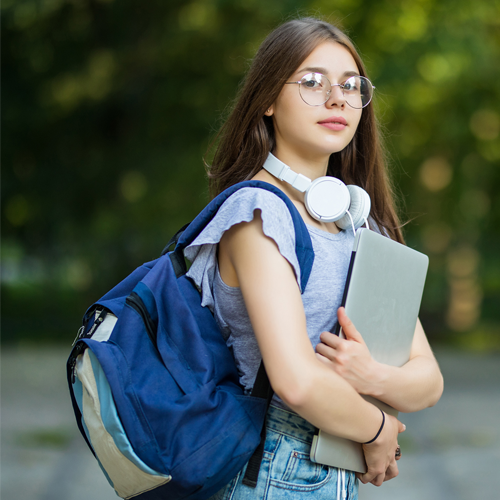 cheerful-attractive-young-woman-with-backpack-notebooks-standing-smiling-park